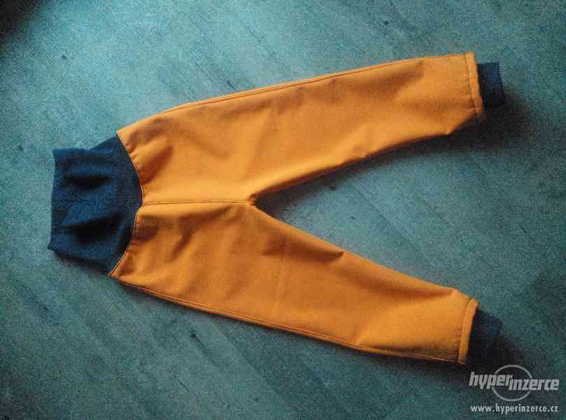 Softshellové kalhoty zimní,oranž. cca 92/98 - foto 1